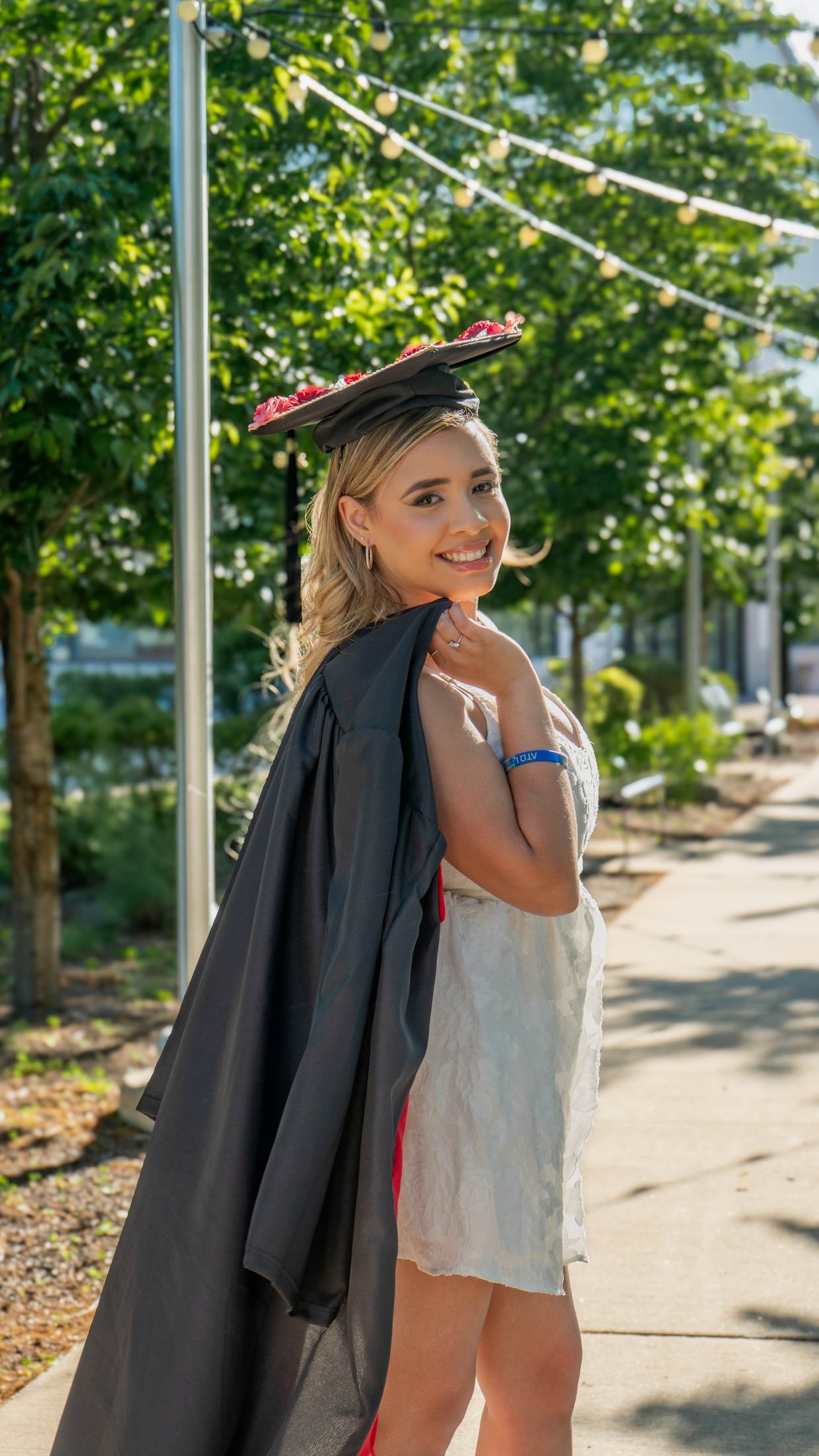 Candid graduation portrait with string lights