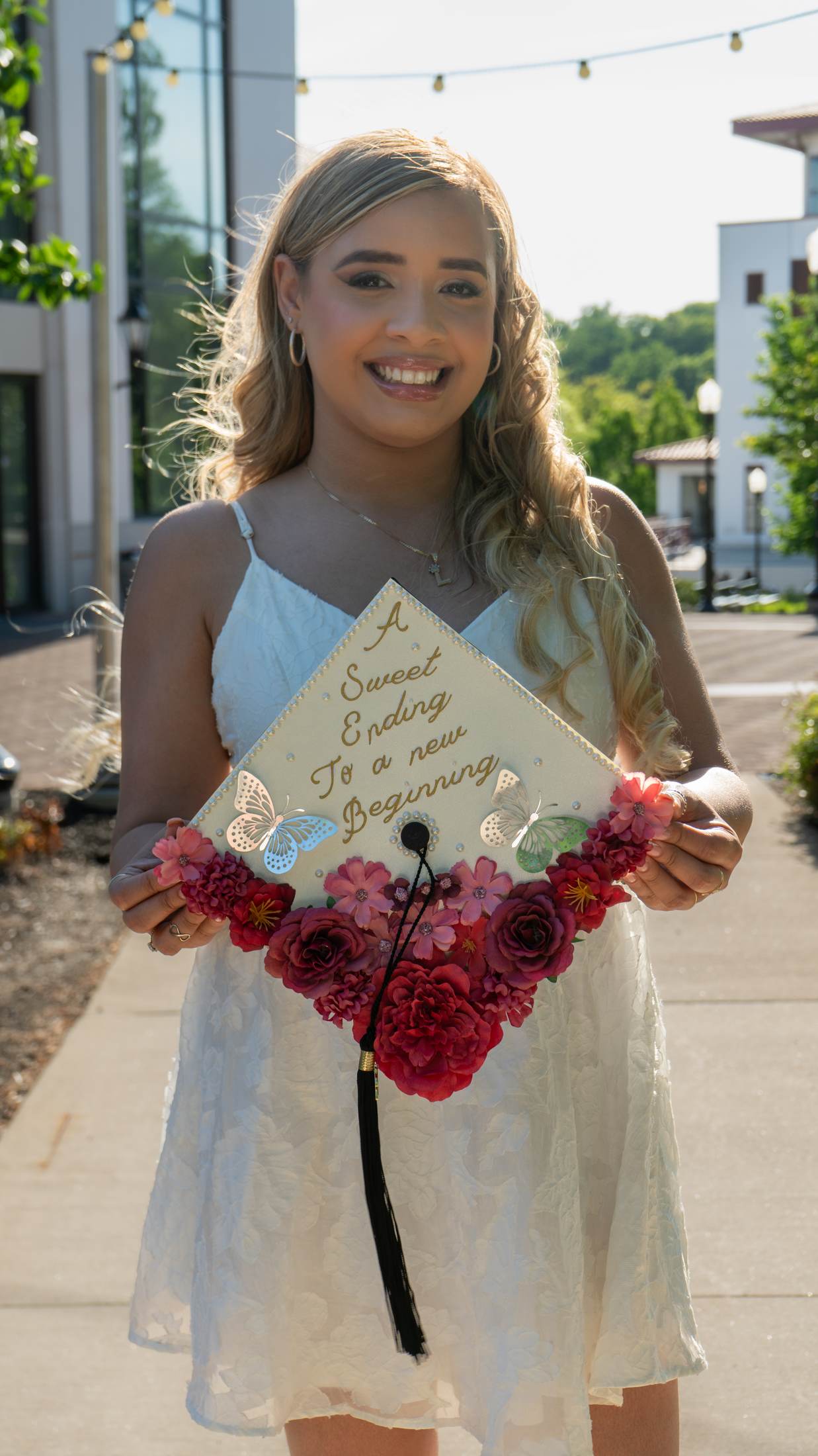 Graduate holding a decorated graduation cap