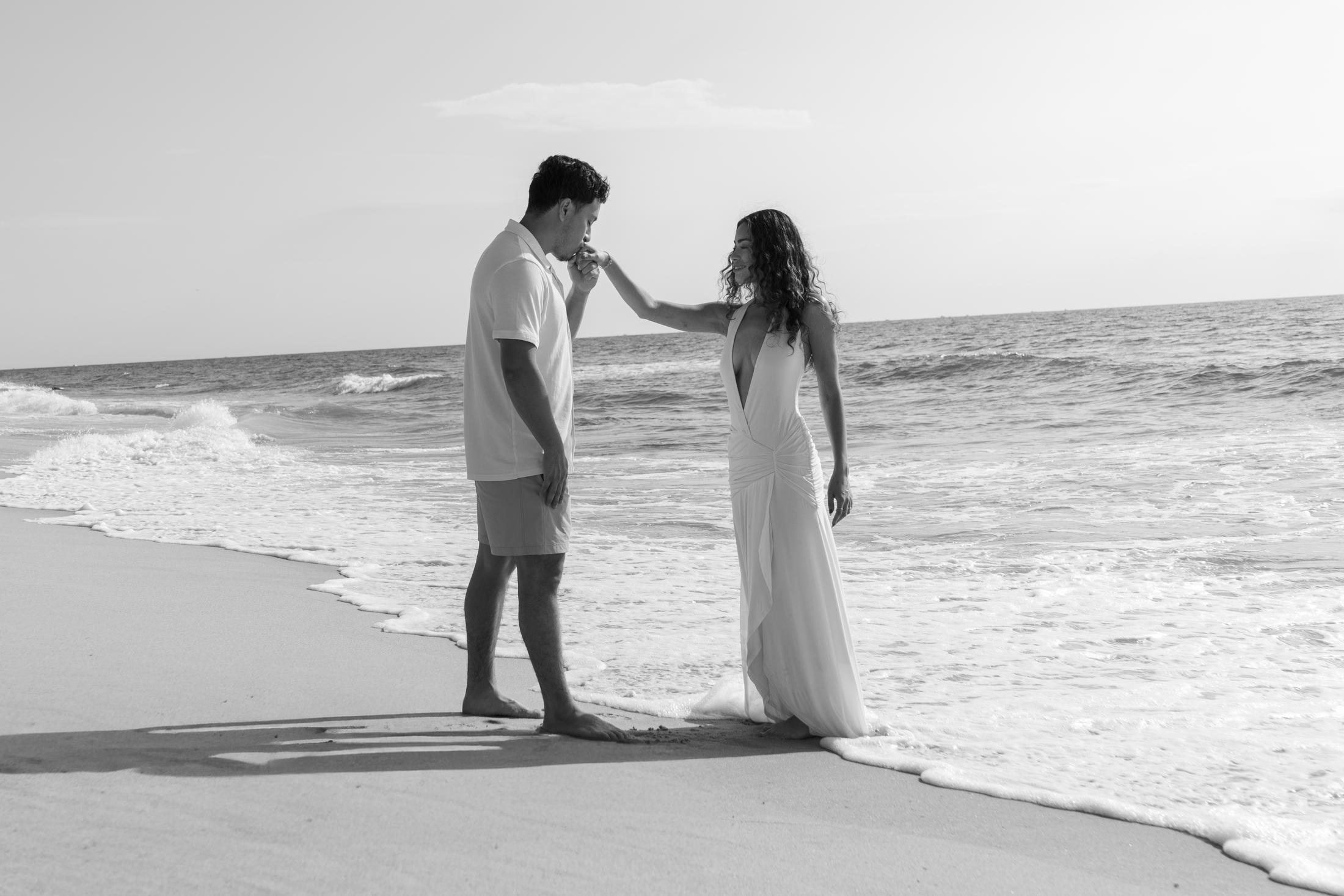 Black and white portrait of a hand kiss on the beach