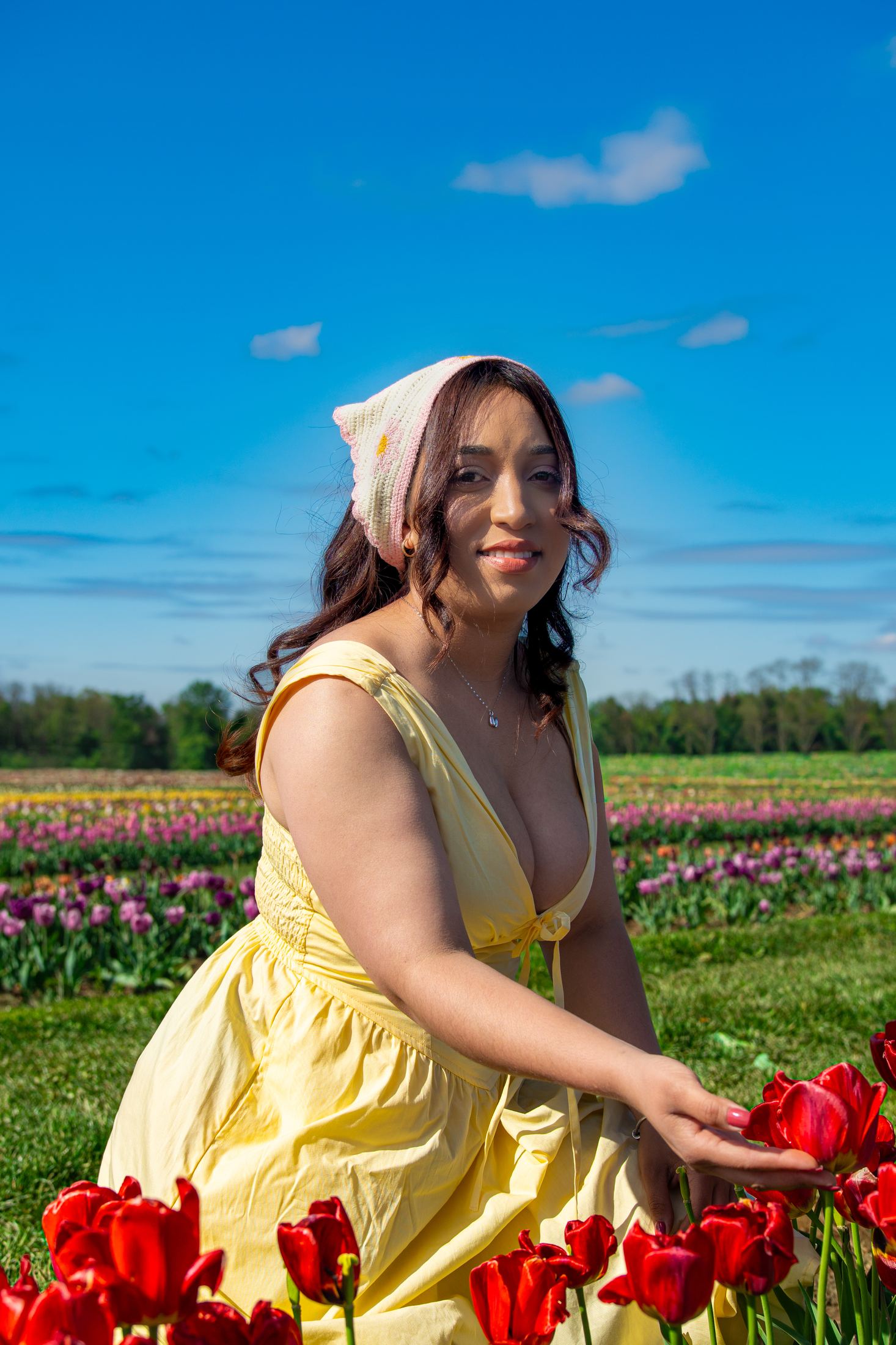 Portrait with knit hat among tulip fields